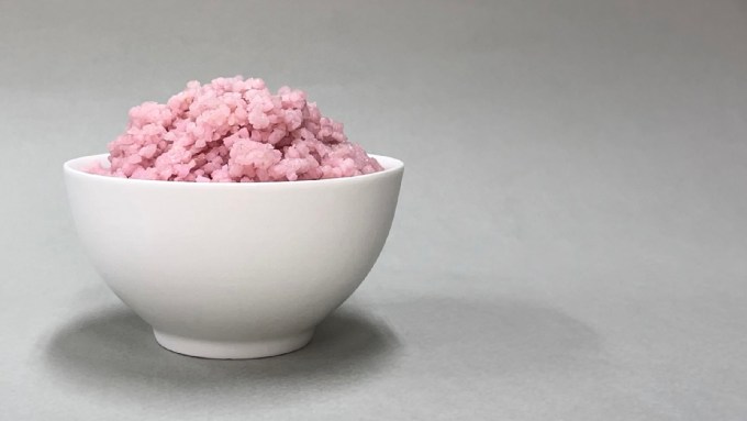 pinkish meat-infused rice in a white bowl