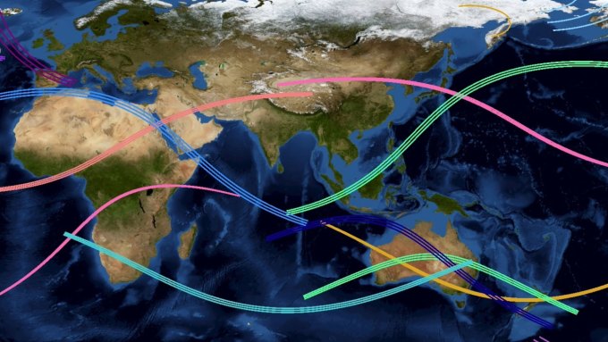 A map of mostly the eastern hemisphere shows multicolored tracks of 13 total solar eclipses over the next 20 years