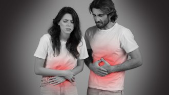 This is stock art of a man and a woman clutching their stomachs as if in pain. Most of the image is black, gray and white, but their T-shirts are colored red in the abdomen area, to denote pain.